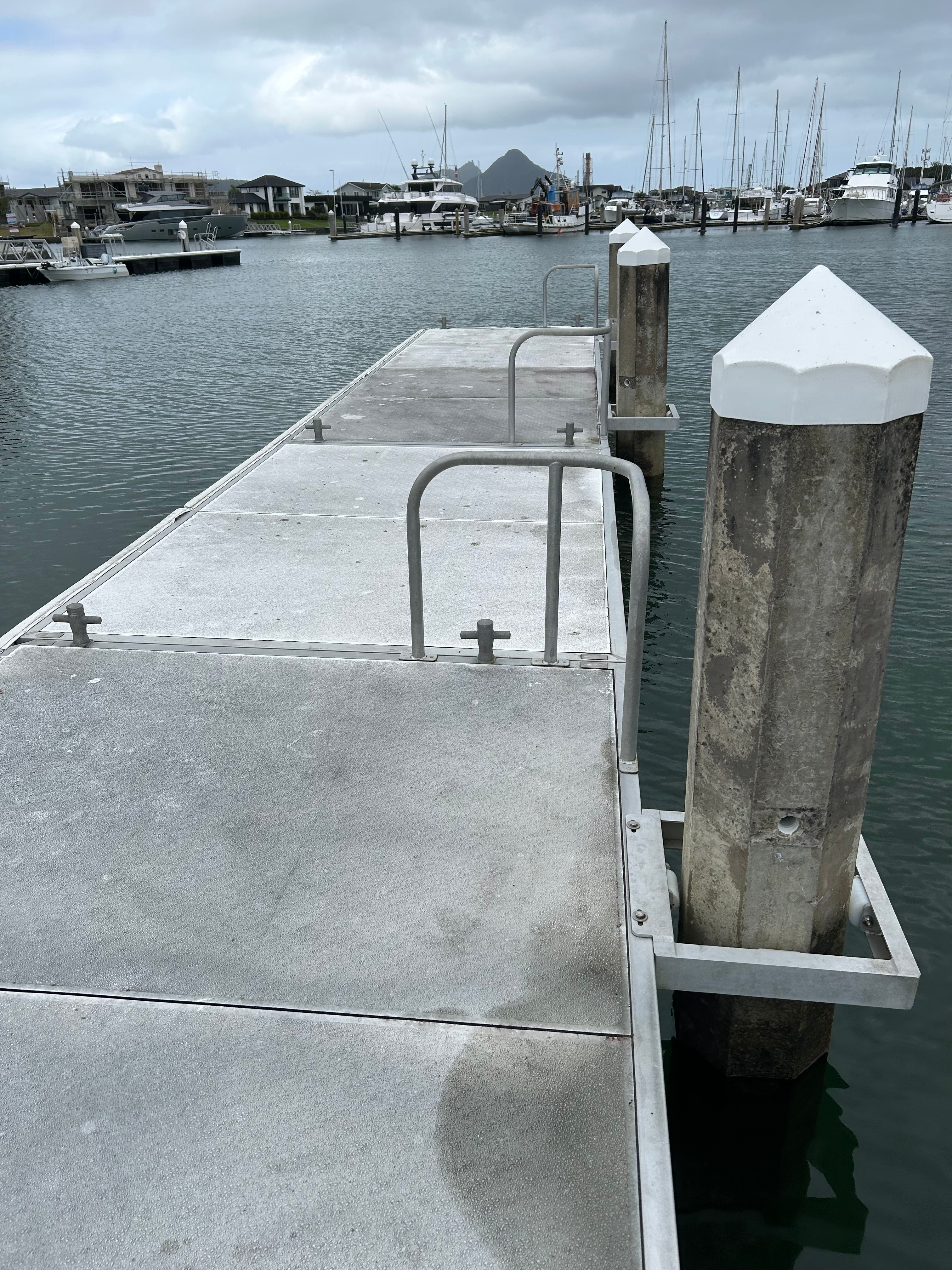 Clean concrete floating pontoon with handrails